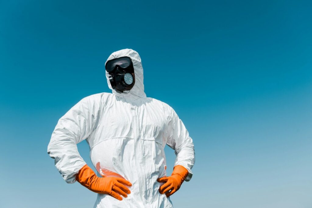 exterminator-in-protective-mask-and-uniform-standing-with-hands-on-hips.jpg